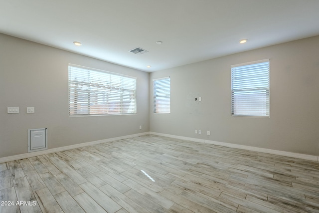 unfurnished room with a wealth of natural light and light hardwood / wood-style flooring