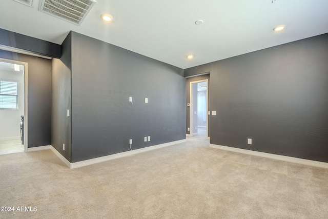 unfurnished room with light colored carpet