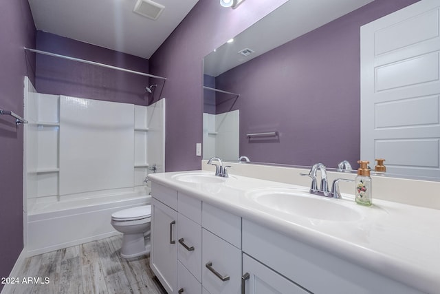 full bathroom featuring toilet, shower / washtub combination, vanity, and hardwood / wood-style flooring