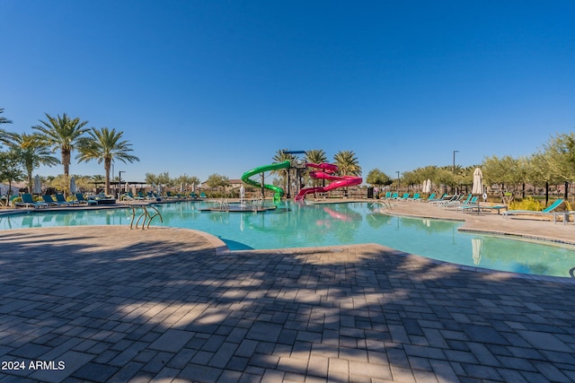 view of pool featuring a patio area and a water slide