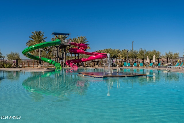 view of swimming pool with a water slide