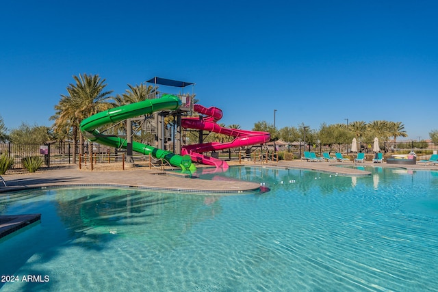 view of swimming pool with a water slide