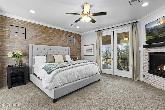 bedroom featuring access to exterior, brick wall, visible vents, and french doors