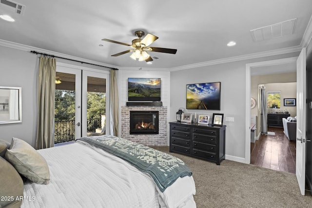 carpeted bedroom featuring ornamental molding, access to outside, and visible vents