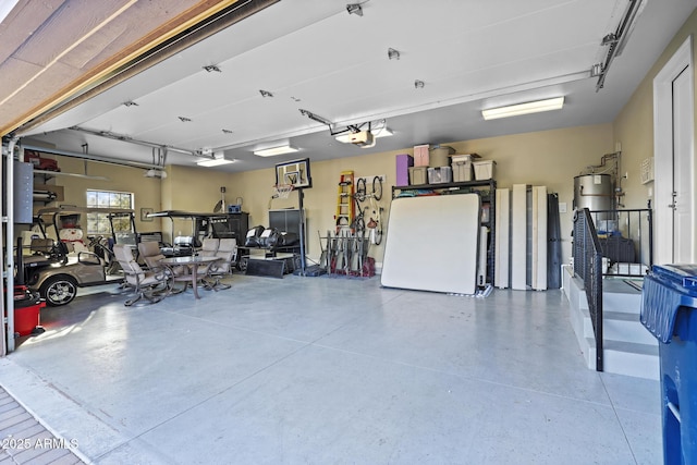 garage featuring a garage door opener, freestanding refrigerator, and water heater