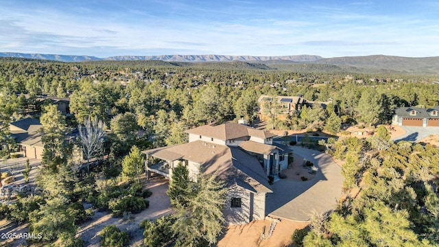 bird's eye view featuring a mountain view and a wooded view