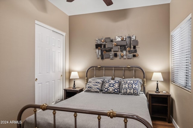 bedroom with a closet, wood-type flooring, and ceiling fan