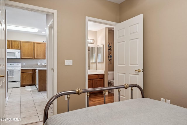 tiled bedroom with connected bathroom