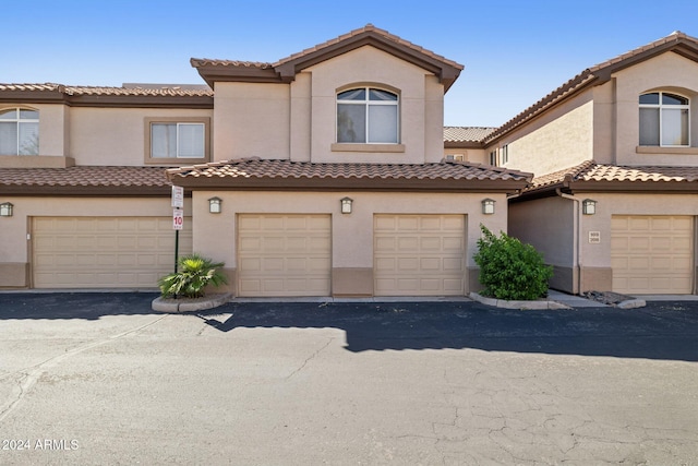 mediterranean / spanish-style home featuring a garage