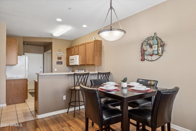 dining space with light hardwood / wood-style floors