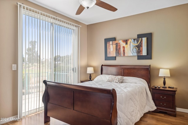 bedroom featuring light hardwood / wood-style floors, access to outside, and multiple windows