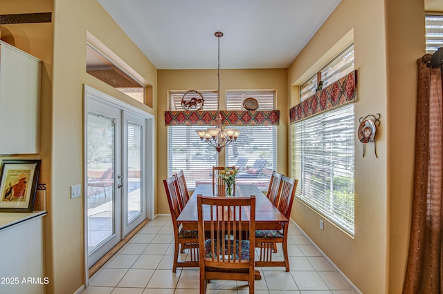 dining space featuring an inviting chandelier, light tile patterned floors, and a healthy amount of sunlight