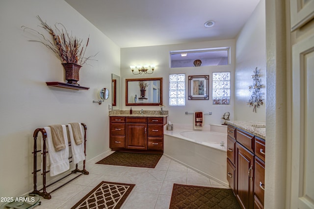 bathroom with a tub to relax in, vanity, a notable chandelier, and tile patterned flooring