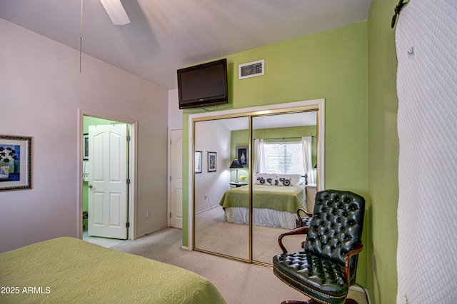 carpeted bedroom featuring a closet and ceiling fan