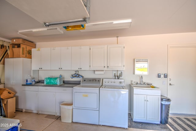 laundry room with washing machine and dryer, sink, and cabinets