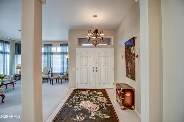 foyer entrance featuring light tile patterned floors and an inviting chandelier