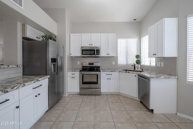 839 W Silver Creek Rd, Gilbert, AZ 85233 - kitchen with appliances with stainless steel finishes, tasteful backsplash, and white cabinets