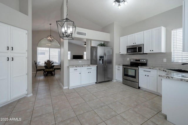 839 W Silver Creek Rd, Gilbert, AZ 85233 - kitchen featuring appliances with stainless steel finishes, tasteful backsplash, lofted ceiling, and white cabinets