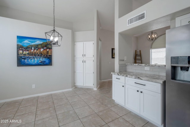 839 W Silver Creek Rd, Gilbert, AZ 85233 - kitchen with stainless steel refrigerator with ice dispenser, a chandelier, white cabinets, pendant lighting, and light stone countertops