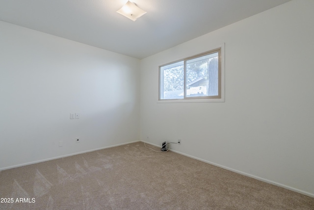 unfurnished room with light colored carpet