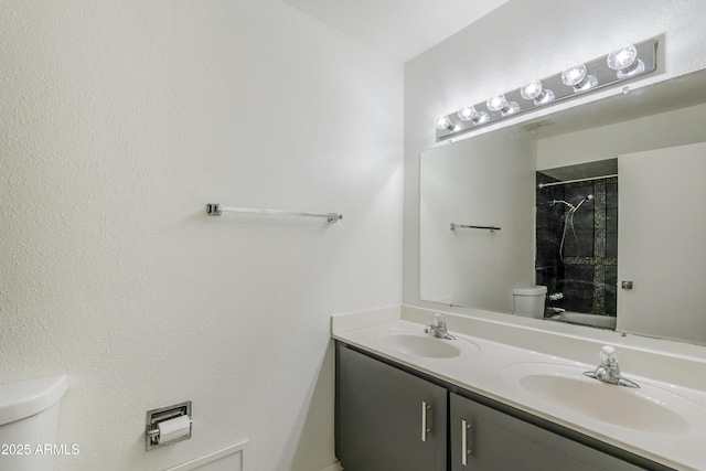 bathroom with vanity, toilet, and walk in shower