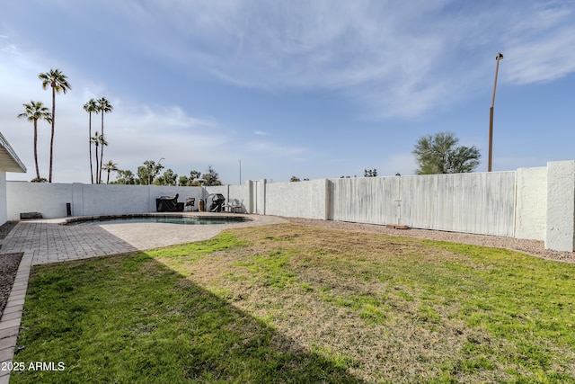 view of yard with a fenced in pool and a patio area