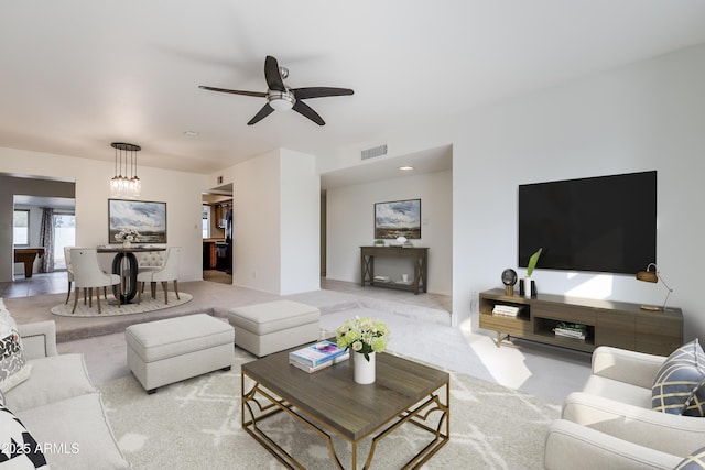 living room featuring ceiling fan and light carpet