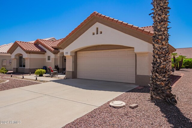 mediterranean / spanish-style home with a garage