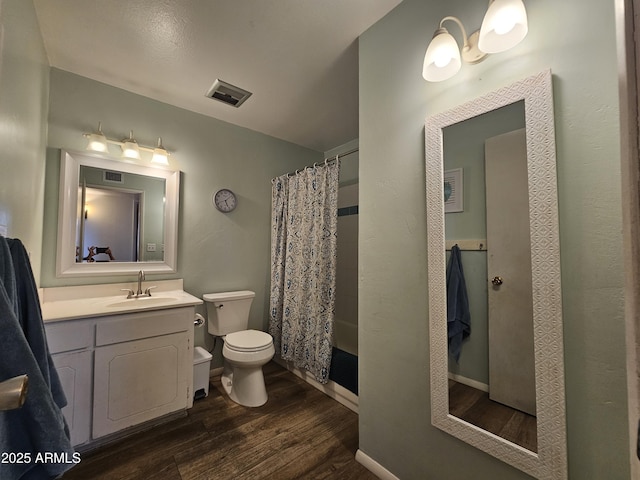 full bathroom featuring visible vents, wood finished floors, toilet, and vanity