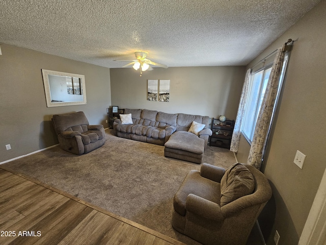 living room with baseboards, a textured ceiling, ceiling fan, and wood finished floors