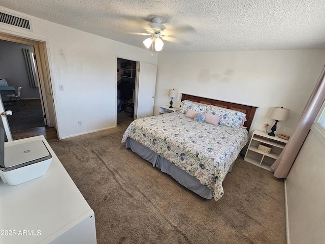 bedroom with carpet, a textured ceiling, and visible vents