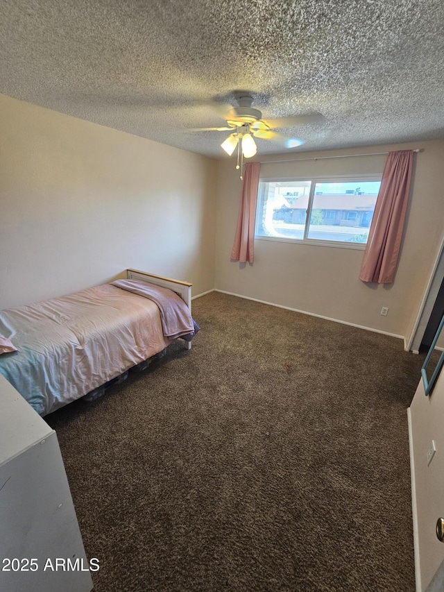 carpeted bedroom with a ceiling fan and a textured ceiling