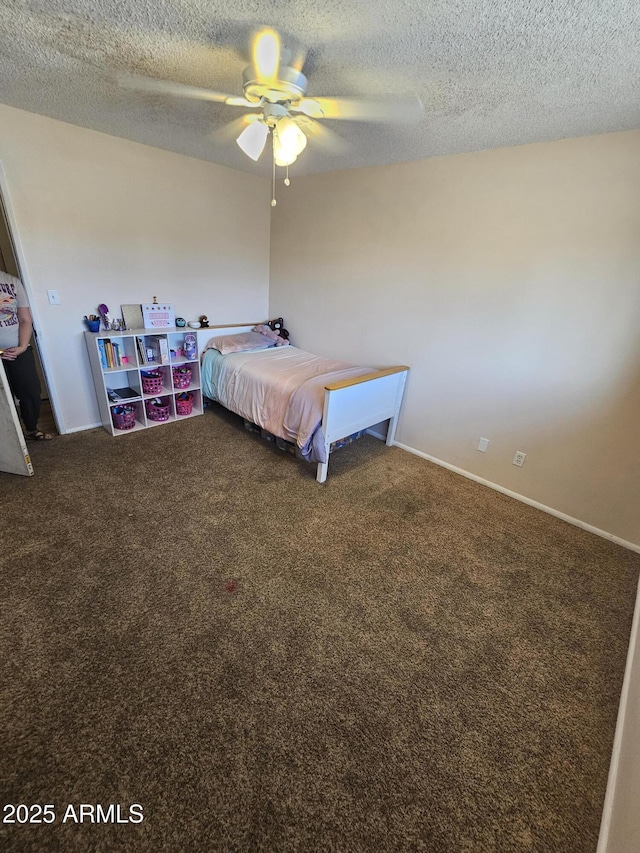 carpeted bedroom with a ceiling fan, a textured ceiling, and baseboards