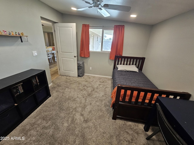 carpeted bedroom with baseboards and a ceiling fan