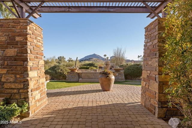 view of patio / terrace with area for grilling and a mountain view