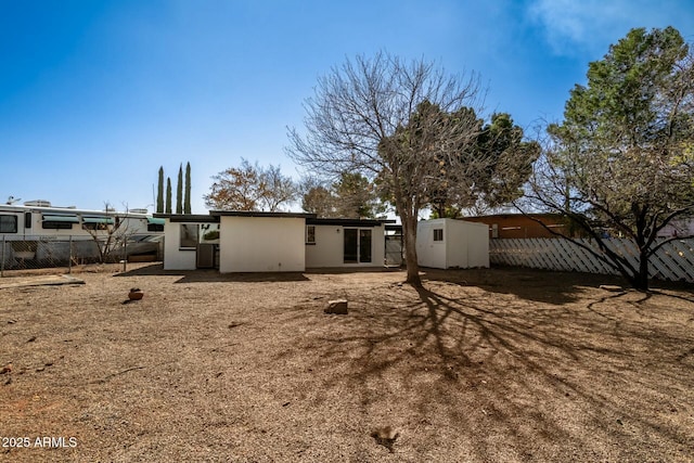 rear view of property featuring fence