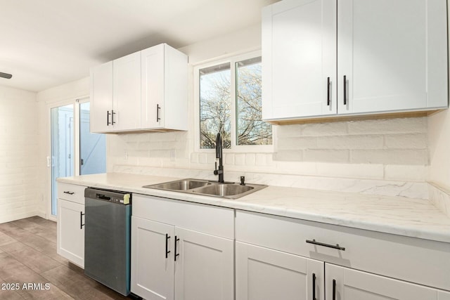 kitchen featuring dark wood-style flooring, decorative backsplash, white cabinetry, a sink, and dishwasher