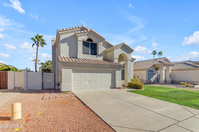 mediterranean / spanish-style home featuring a garage and a front lawn