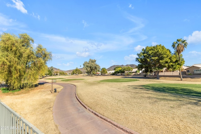 surrounding community featuring a mountain view and a yard