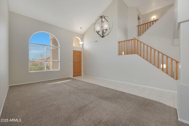 interior space featuring high vaulted ceiling, light carpet, and a chandelier