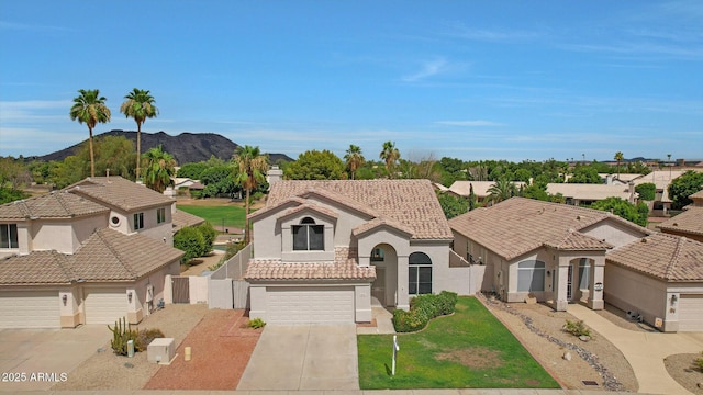 mediterranean / spanish-style home featuring a garage and a mountain view