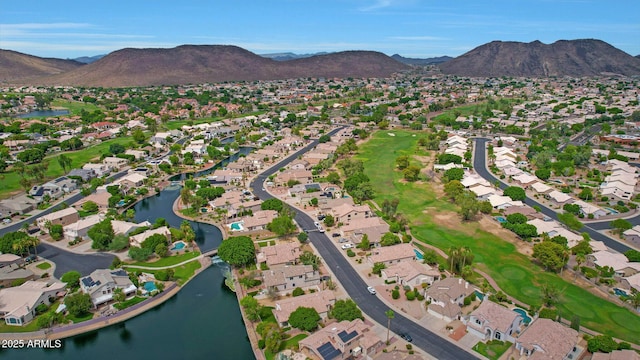 birds eye view of property with a water and mountain view