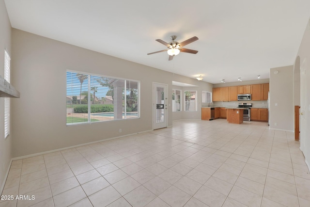 unfurnished living room with ceiling fan and light tile patterned floors