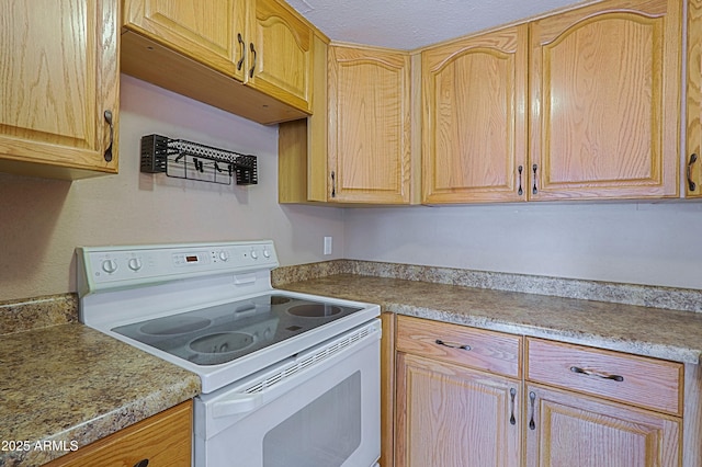 kitchen with light countertops, electric range, and light brown cabinets