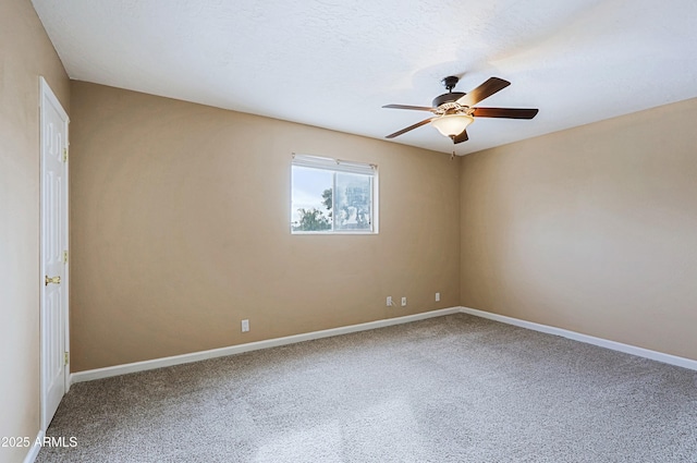 carpeted empty room with ceiling fan, a textured ceiling, and baseboards