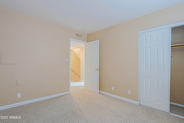 unfurnished bedroom with carpet floors and baseboards