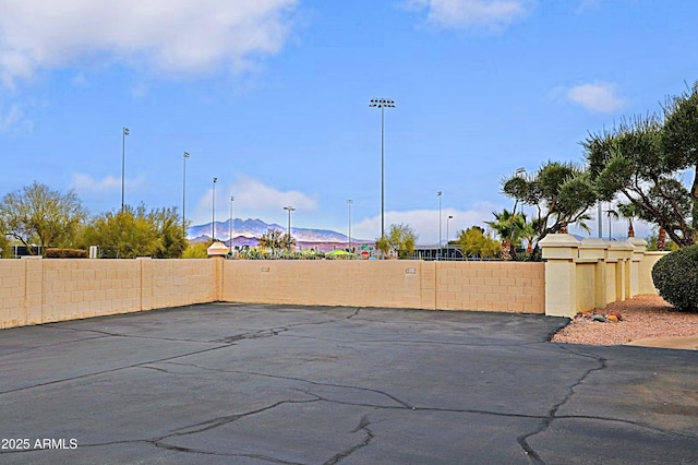 view of patio / terrace featuring fence and a mountain view