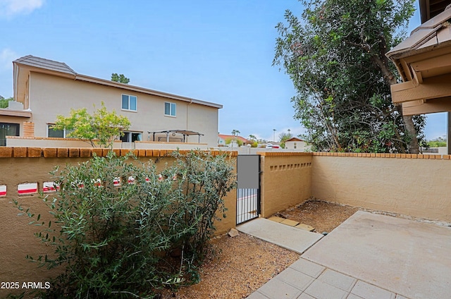 view of patio / terrace with a fenced backyard and a gate