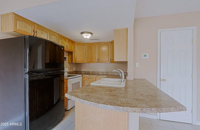 kitchen featuring freestanding refrigerator, a peninsula, a sink, light countertops, and white range with electric cooktop