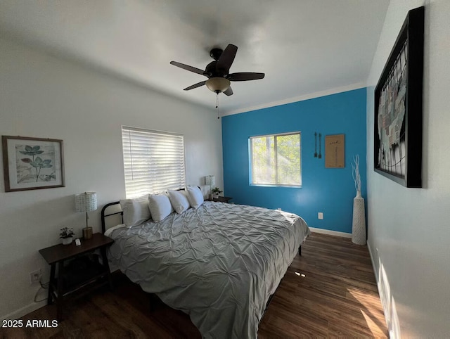 bedroom with wood finished floors, a ceiling fan, and baseboards